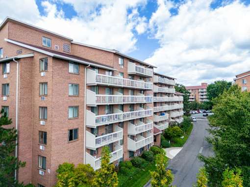 a view of an apartment building with a street in front of it