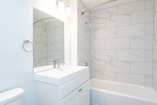 a white bathroom with a sink and a mirror