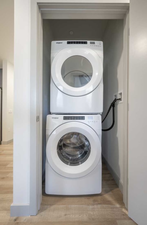a washer and dryer stacked on top of each other in a laundry room