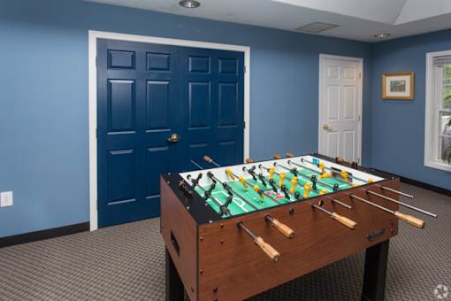 A foosball table in a room with blue walls.