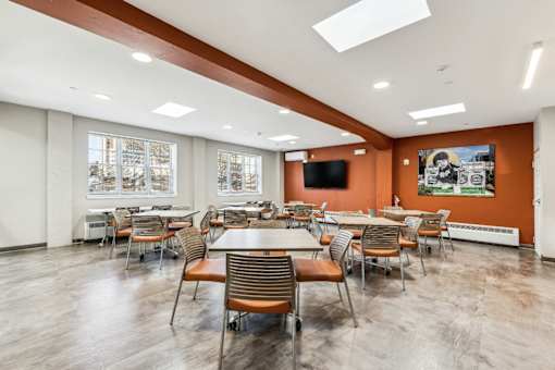 A conference room with a long table and chairs.