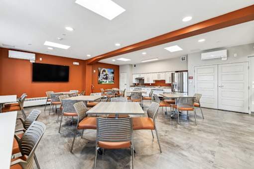 A conference room with a long table and chairs.