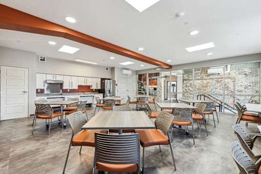 A modern dining room with a long table and chairs.