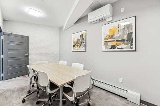 A conference room with a long table and chairs.