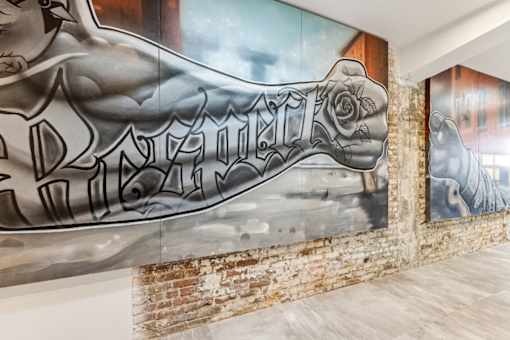 A mural of a muscular arm with the word "Romeo" written on it.