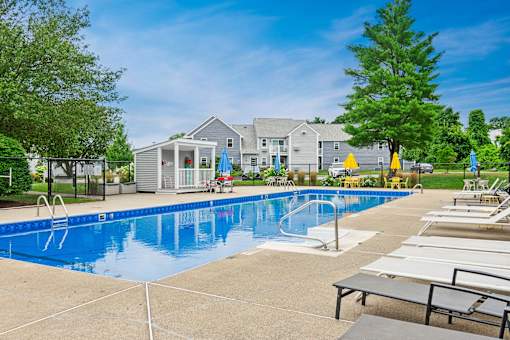 our apartments have a large swimming pool and lounge chairs at Blue Hills Village, Canton, Massachusetts