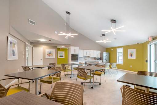 Community room with tables and chairs at Station Pointe Apartments, Mansfield, MA, 02048