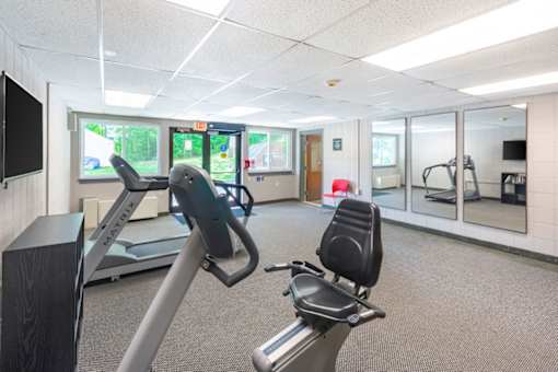 A gym with treadmills and exercise bikes.