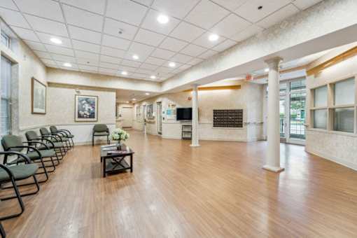 a waiting room with chairs and a table in the lobby of a hospital  at Monterey Place, New Haven, CT, 06511