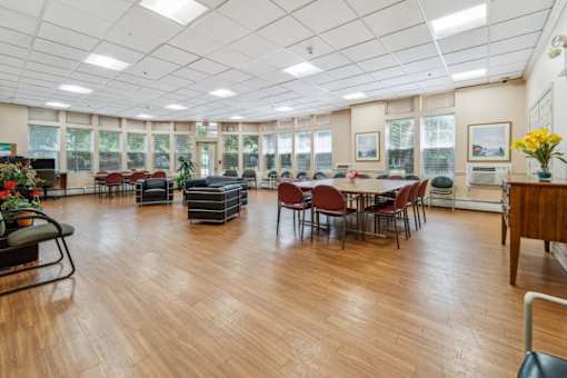 a large room with a table and chairs in the center of it  at Monterey Place, New Haven
