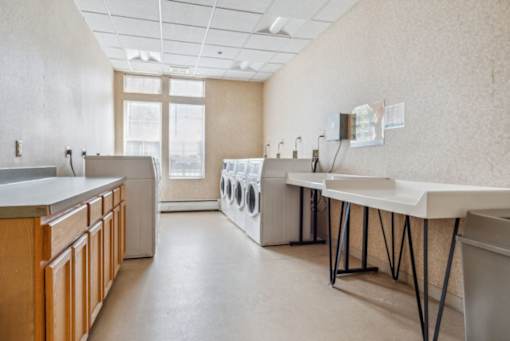 a laundry room with sinks and washes and dryers in it  at Monterey Place, New Haven, CT, 06511