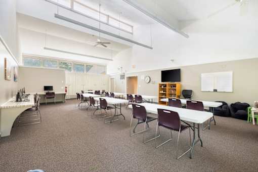 Community classroom with tables and whiteboard at Blue Ridge Estates Apartments, Virginia, 23225