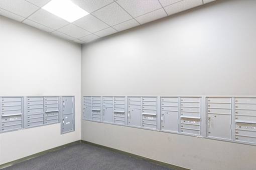 A row of white mailboxes on a wall at Edmands House, Framingham, 01701