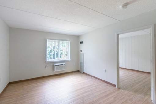 A room with a window and a door.
