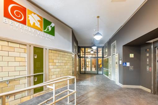 a hallway with a sign for the for living and the arts at Beverly Village for Living & the Arts Apartments, Beverly, 01915