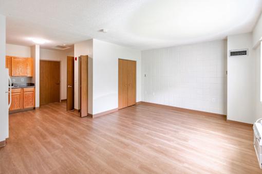 A room with wooden floors and white walls.