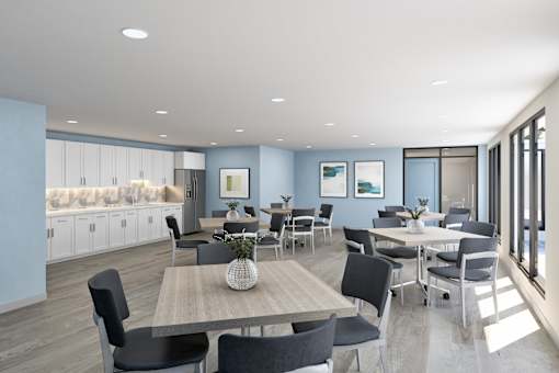 A modern dining room with a long table and chairs.