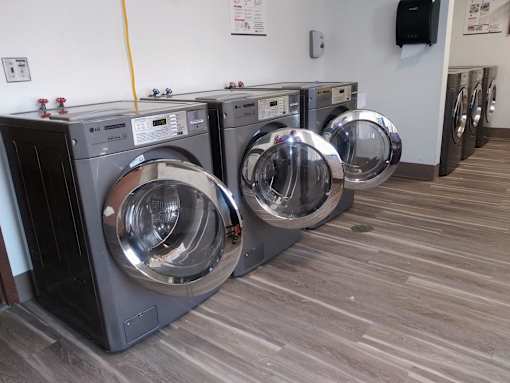 A row of washing machines in a laundromat.