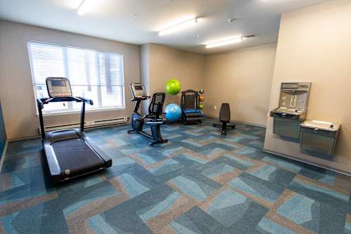A room with a treadmill, exercise ball, and other workout equipment. at 35 Broadway Apartments, Menands, NY