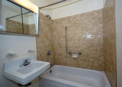 Full Bathroom With Shower And Bathtub Sycamore Place Apartments.