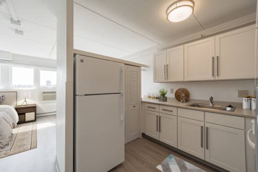 Modern kitchen with white cabinets and stainless appliances at Baystate Place Apartments, Springfield, 1104