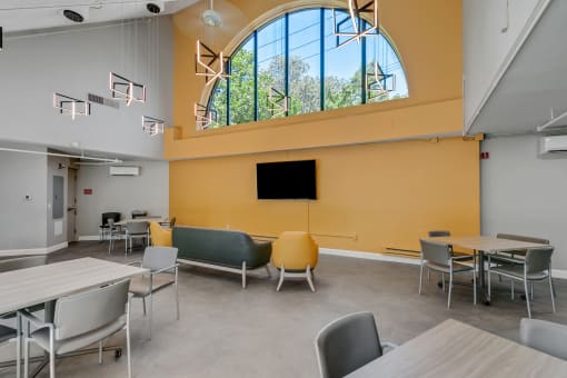 a large room with tables and chairs and a large window