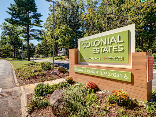 A sign for Colonial Estates is displayed in front of a landscaped area at Colonial Estates Apartments, Springfield, Massachusetts 01119