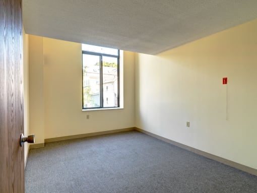 Carpeted Bedroom at Robinson Cuticura Mill Apartments in Malden , MA.