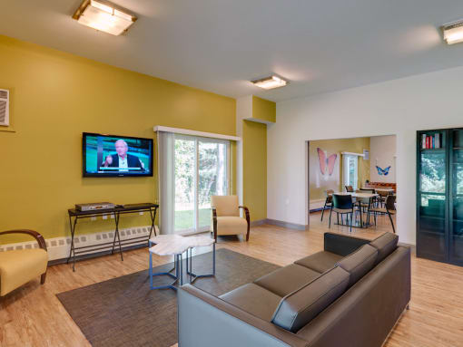 Community Room with Lounge and TV at Wilkins Glen Apartments in Medfield, MA.