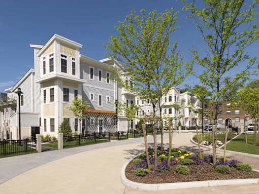 A row of houses with a small garden in front. at The Anne M. Lynch Homes at Old Colony, South Boston