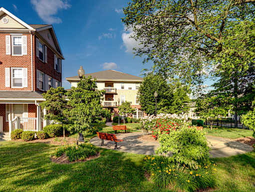 a park with a bench in front of a building  at Monterey Place, New Haven, CT, 06511