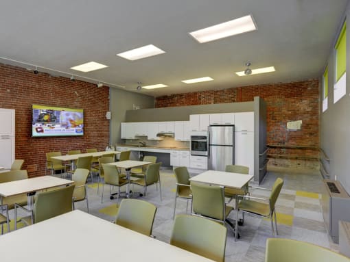 Community Clubroom with TV and Kitchen at Robinson Cuticura Mill Apartments in Malden , MA.