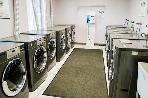 A row of washing machines in a laundromat.