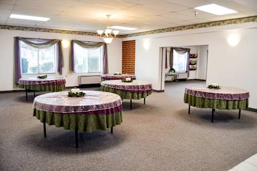 A room with tables set up for a function.