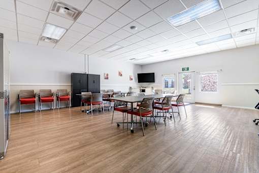 A conference room with a long table and chairs.