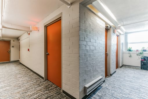 a pair of orange doors in a hallway