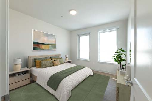A bedroom with a large bed and a painting on the wall. at The Anne M. Lynch Homes at Old Colony, South Boston, MA