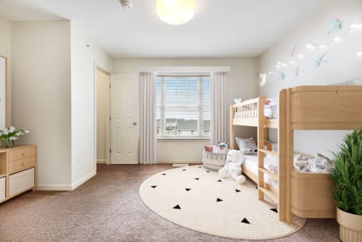 a bedroom with two bunk beds and a round rug at Creekwood Apartments, Watertown, 13601