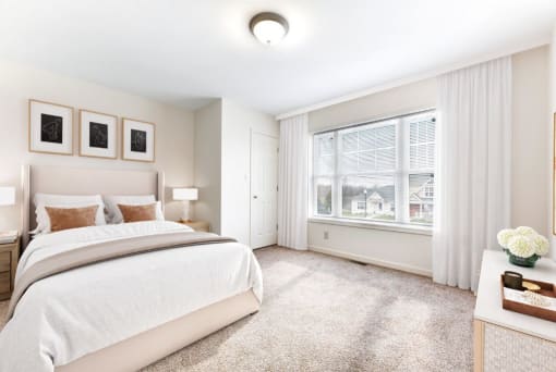 a bedroom with a large bed and a large window  at Summit Wood Apartments, Watertown, 13601