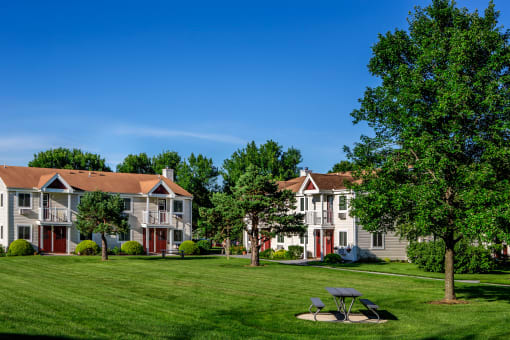 Exterior View of Apartments with Outdoor Picnic Table and Green Space. at Pheasant Hill Estates, Harrisburg, PA, 17110