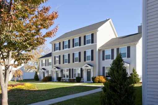 Exterior Of Building With Front Yard And Driveway.