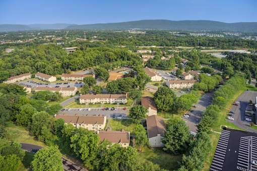 A bird's eye view of a residential area with houses and trees at Williamsburg Estates, Harrisburg, PA, 17112