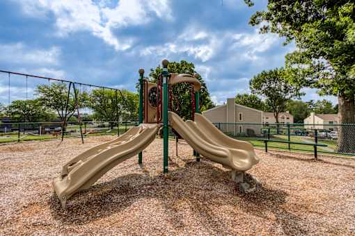 A playground with a slide and a swing set at Williamsburg Estates, Harrisburg, PA, 17112