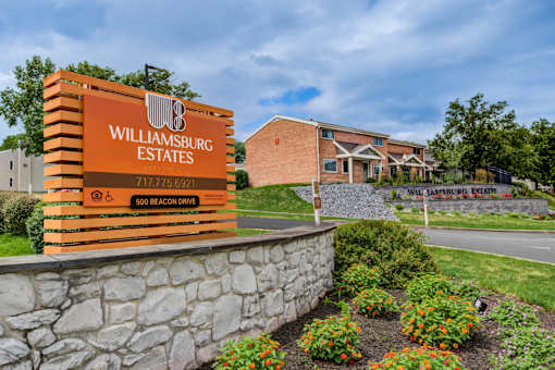 A sign for Williamsburg Estates is displayed in front of a building at Williamsburg Estates, Harrisburg, PA, 17112