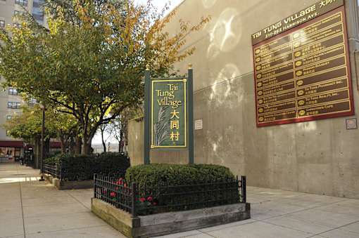 a sign for the times village on the side of a building