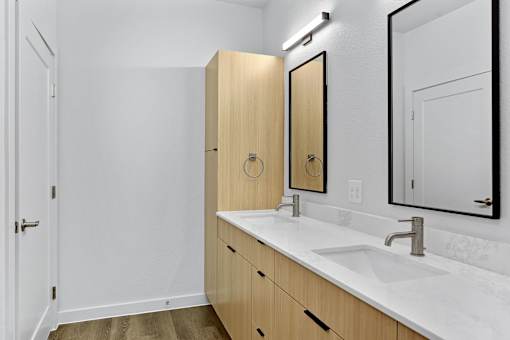 A bathroom with a sink, mirror, and medicine cabinet.