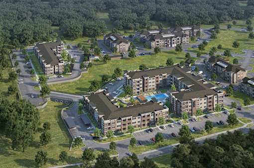 A bird's eye view of a residential complex with multiple buildings and a swimming pool.