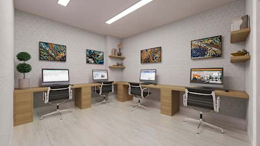 A modern office space with computers and artwork on the walls.