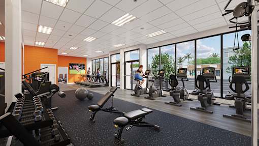 A gym with a variety of equipment including treadmills, weights, and exercise machines.