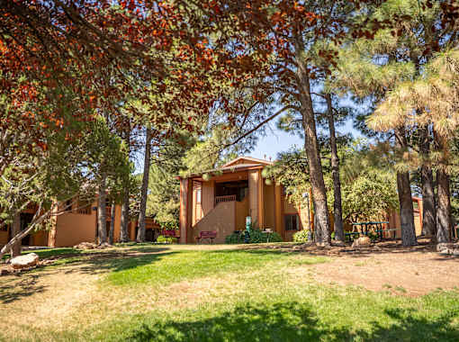 A house surrounded by trees with red leaves.